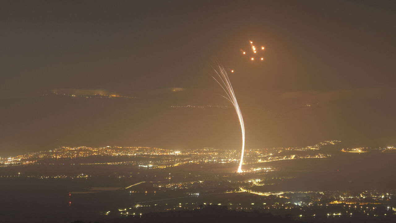 Rockets fired from southern Lebanon are intercepted by Israel's Iron Dome air defence system over the Upper Galilee region in northern Israel, on July 15, 2024, amid ongoing cross-border clashes between Israeli troops and Lebanon's Hezbollah fighters. (Photo by Jalaa MAREY / AFP) (Photo by JALAA MAREY/AFP via Getty Images)