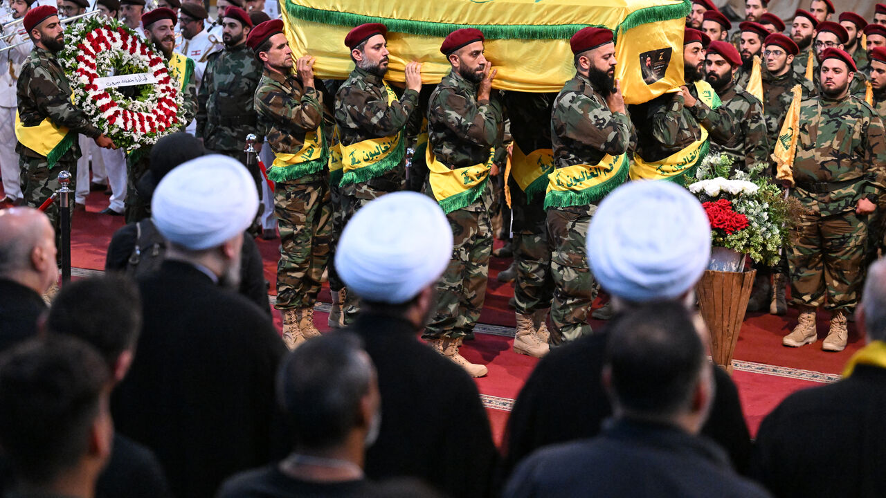 Hezbollah fighters carry the flag-draped coffin of slain top commander Fuad Shukr during his funeral in Beirut's southern suburbs on August 1, 2024. Hezbollah on August 1 mourned Shukr, whose body was recovered from the rubble of a July 30 Israeli strike in south Beirut that also killed five civilians, three women and two children, and injured dozens, according to Lebanon's health ministry, as fears mounted of a wider conflict in the region. (Photo by Khaled DESOUKI / AFP) (Photo by KHALED DESOUKI/AFP via G