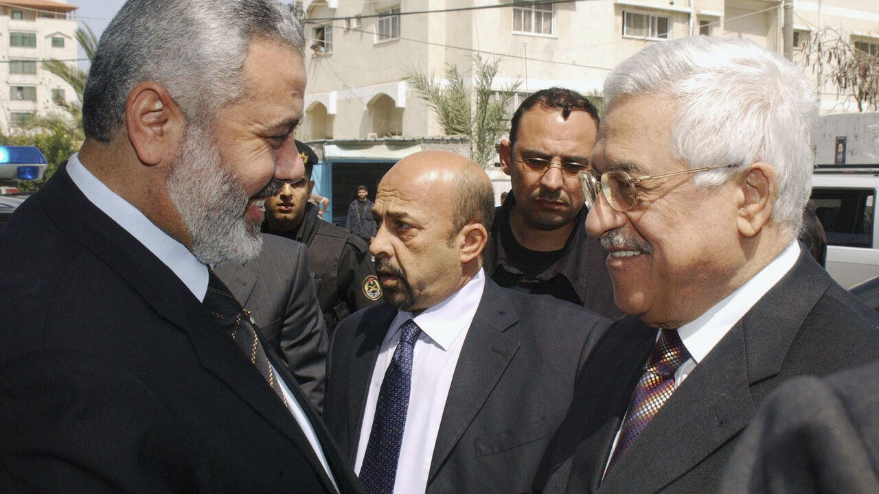 In this handout image supplied by the Palestinian Press Office (PPO), Palestinian Prime Minister Ismail Hanyeh smiles with Palestinian President Mahmoud Abbas, outside Haniyeh's office before holding talks on April 5, 2007 in Gaza, Gaza Strip. Haniyeh today meet with British Consul General in Jerusalem, Richard Mikbis, to discuss the kidnapping of BBC journalist Alan Johnston who went missing on March 12, 2007. (Photo by Abu Askar/PPO via Getty Images)