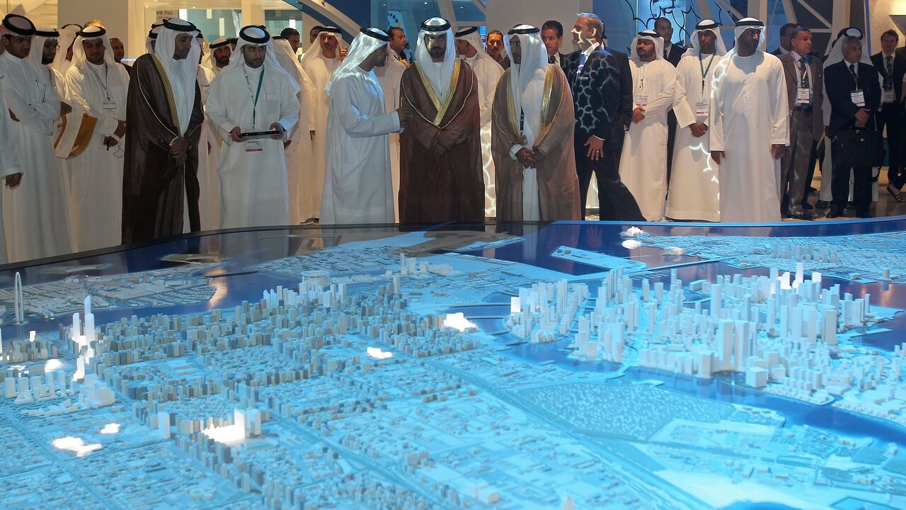 Sheikh Hamed bin Zayed Al Nahyan (C), who was recently named to head the Abu Dhabi Investment Authority, looks at a model of the Capital City District project.