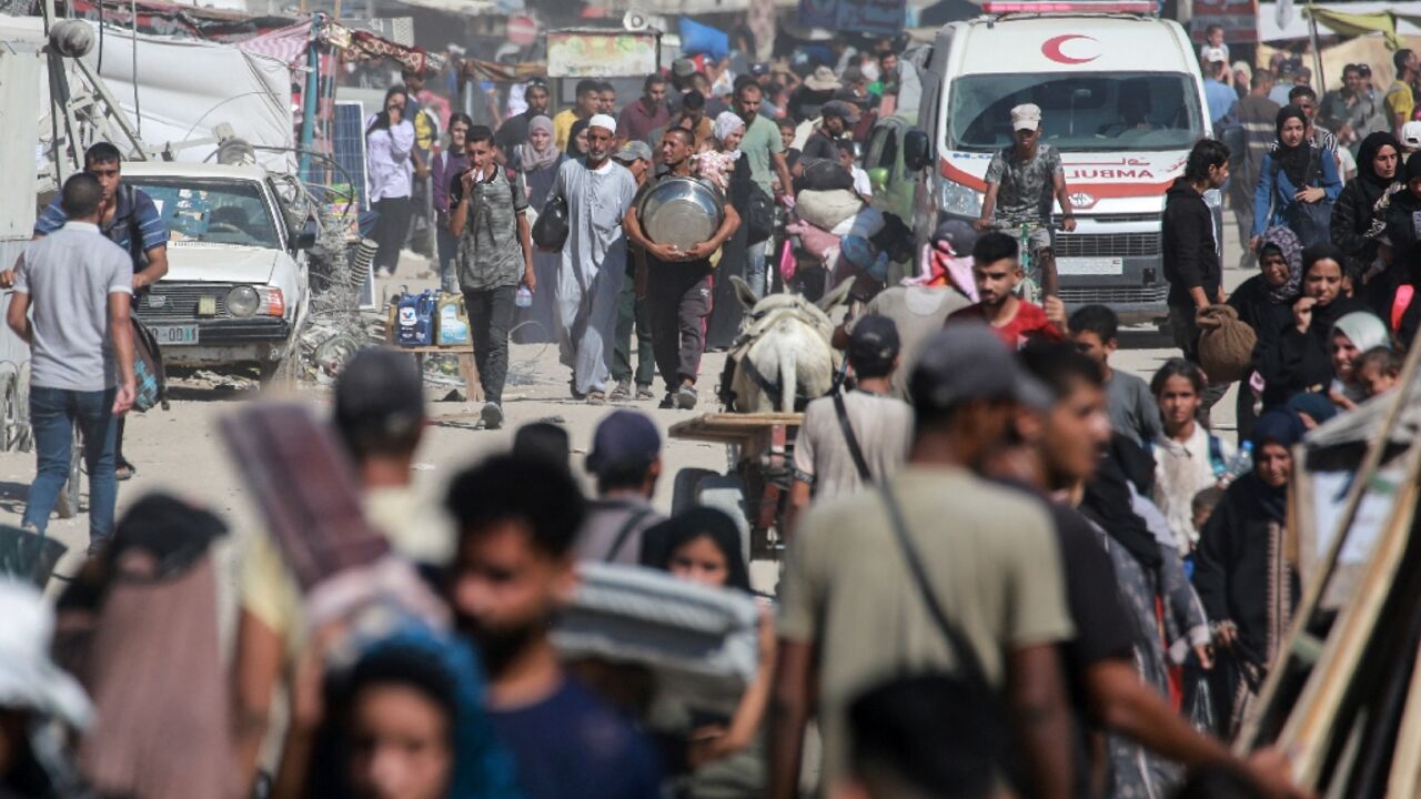 Displaced Palestinians leave an area of Khan Yunis city in Gaza after a new Israeli evacuation order