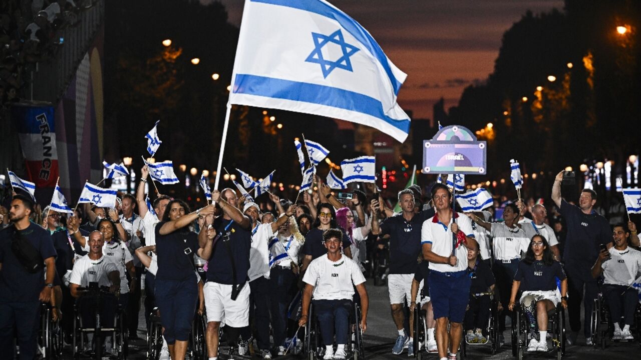 Adam Berdichevsky (R) said he was happy to give his family and other survivors in their kibbutz of the Hamas October 7 attacks something to smile about after winning his opening Paralympics tennis match 