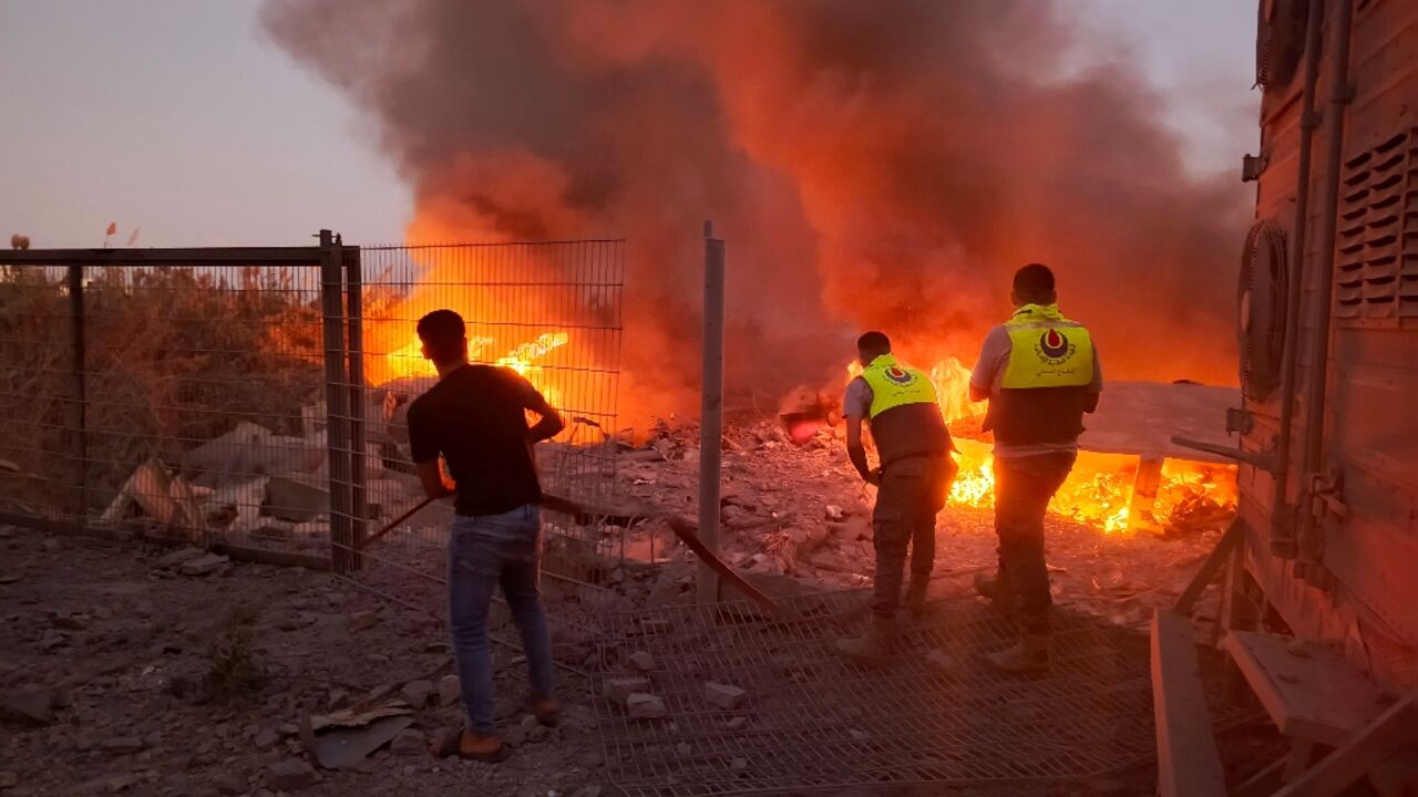 Rescuers rush to the scene of an Israeli airstrike that targeted the southern Lebanese village of Abbasiyeh on September 24, 2024