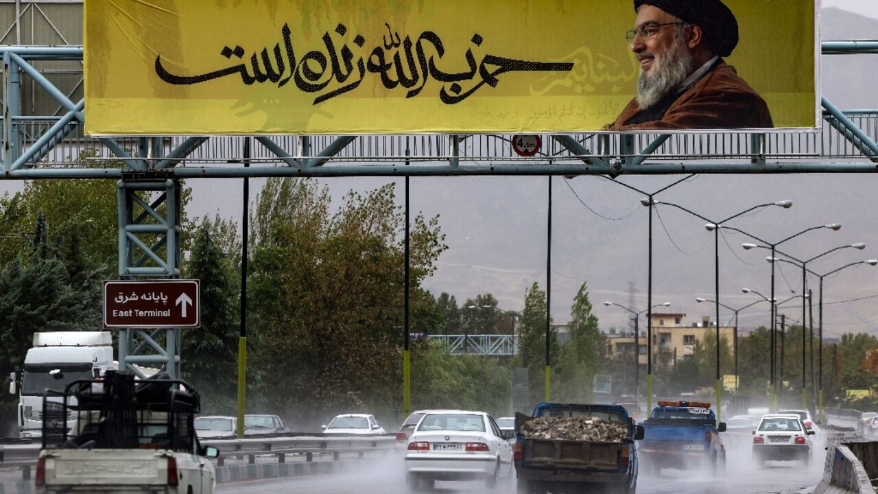 A picture of Hezbollah leader Hassan Nasrallah reads in Farsi, 'Hezbollah is alive', in northern Tehran before the Lebanese movement confirmed his death, which Israel said occurred in a strike on Beirut