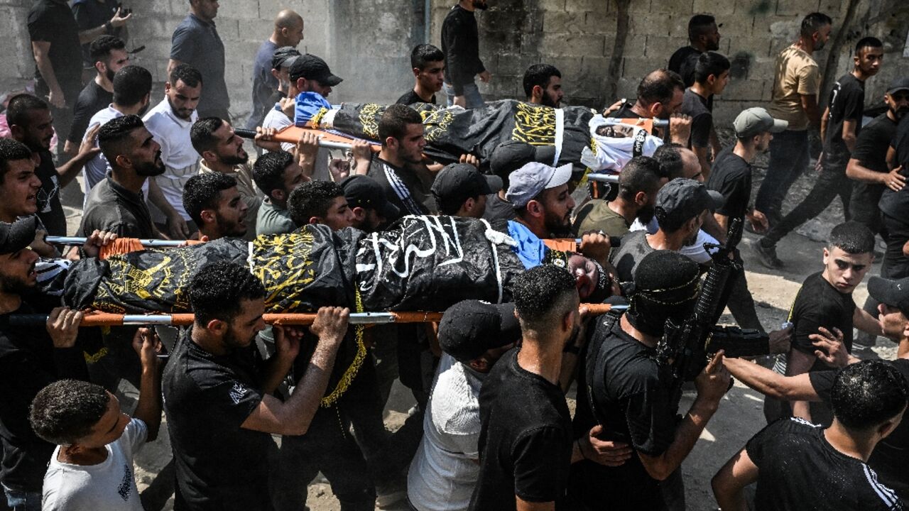 Mourners in the Jenin refugee camp carry the bodies of Palestinians killed during the Israel raid