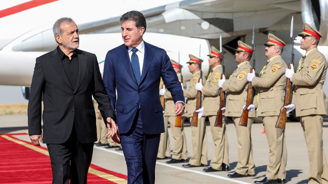 The president of Iraq's autonomous Kurdistan region, Nechirvan Barzani, welcomes Iran's President Masoud Pezeshkian at Arbil airport