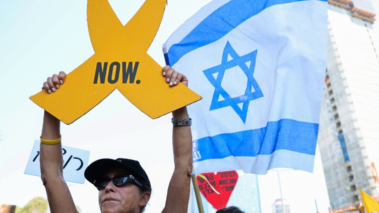 Families and supporters of Israelis held hostage in the Gaza Strip since October, block traffic during a rally in Tel Aviv