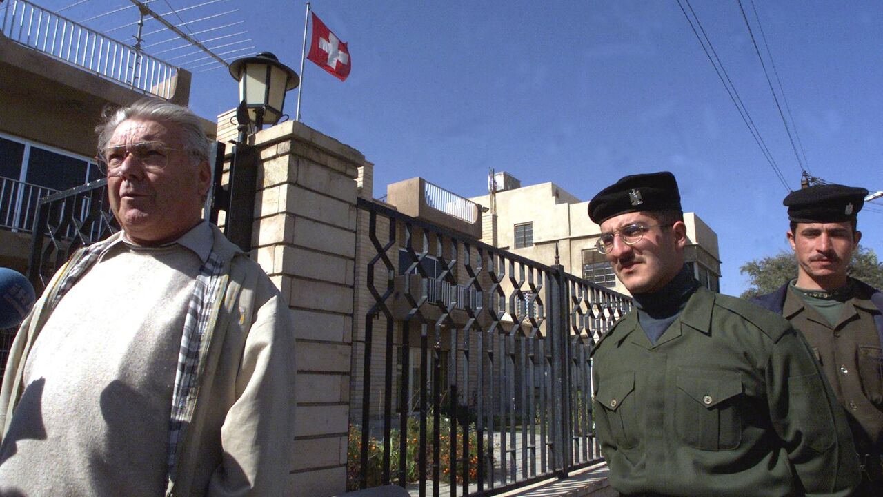 Kurt Reiniger, Swiss diplomat in charge of humanitarian affairs (L), arrives at the Swiss Embassy in Baghdad, on February 2, 2001. 