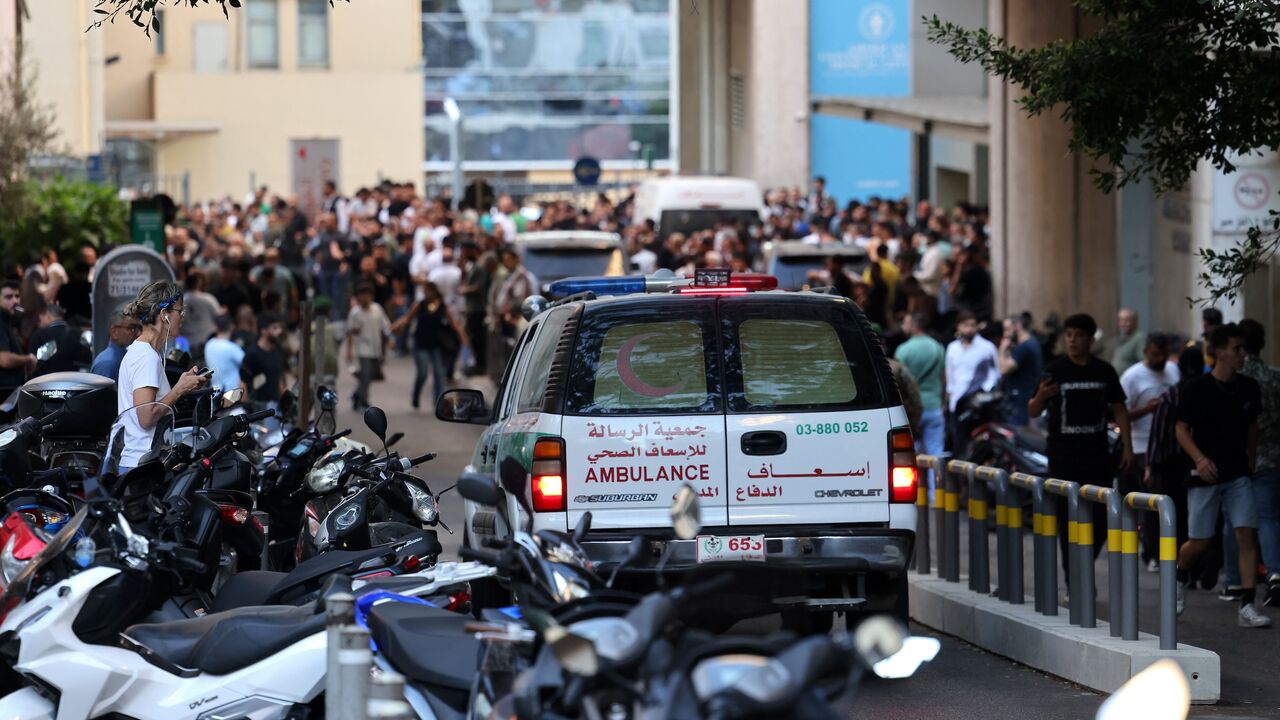 An ambulance rushes wounded people to the American University of Beirut Medical Center, on Sept. 17, 2024.