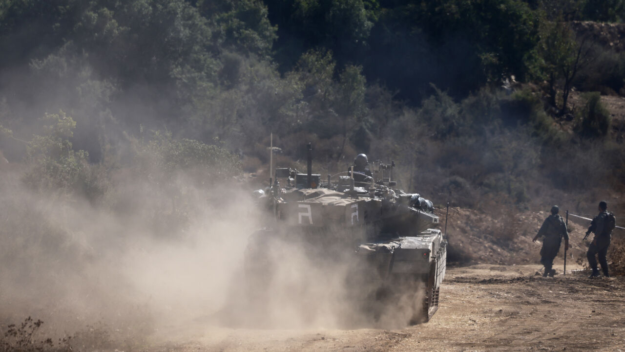 An Israeli tank drives to a position in the Upper Galilee region of northern Israel near the border with Lebanon on September 29, 2024. Israel said on September 29, it killed another senior Hezbollah official in an air strike after dealing the Iran-backed group a seismic blow by assassinating its leader, Hassan Nasrallah. (Photo by Menahem KAHANA / AFP) (Photo by MENAHEM KAHANA/AFP via Getty Images)