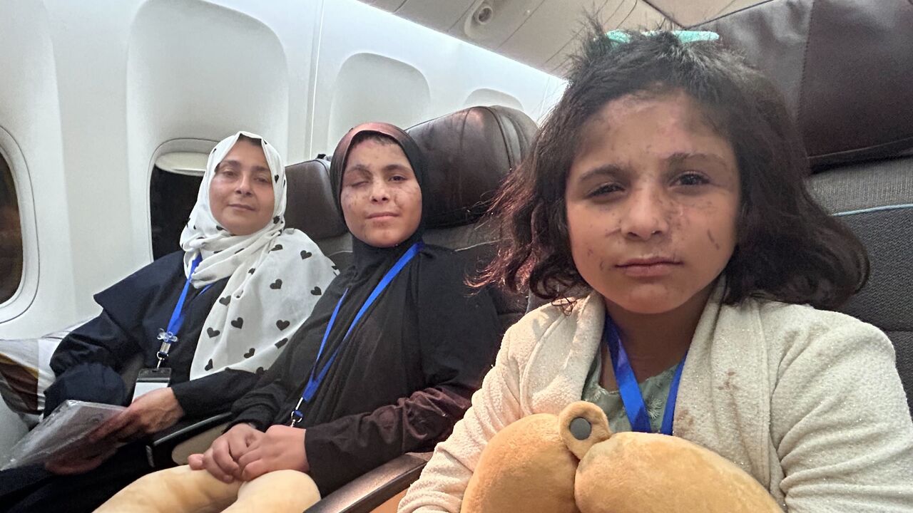 Mayssa (C), 15, and Yara (R), 10, from Khan Younis, on board the UAE evacuation flight that arrived from Eilat to Abu Dhabi on Sept. 9, 2025. 