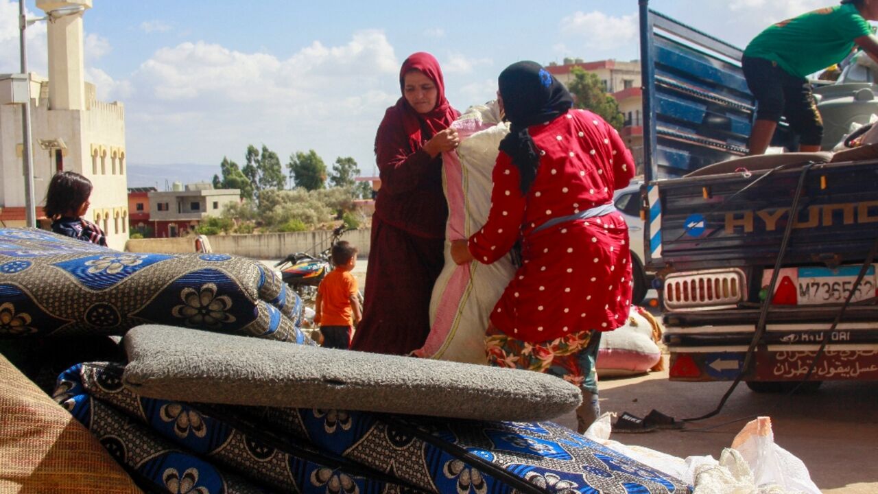 Syrians load their belongings on a truck as they prepare to leave Wazzani after the warning in the leaflets