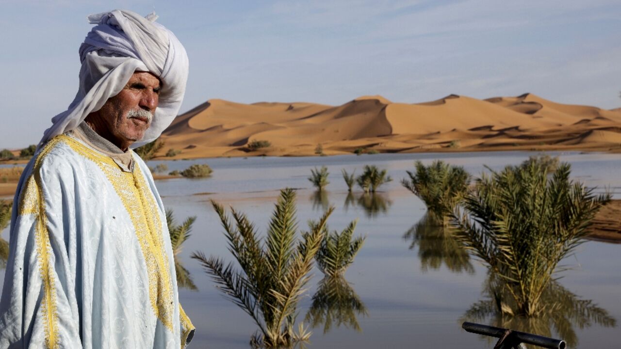 A local man poses for a picture at Yasmina Lake, a seasonal lake in the village of Merzouga in the Sahara desert in southeastern Morocco