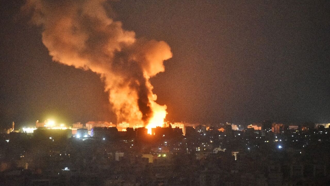 Fire and smoke rise over an area targeted by an Israeli air strike on Beirut's southern suburbs on October 6