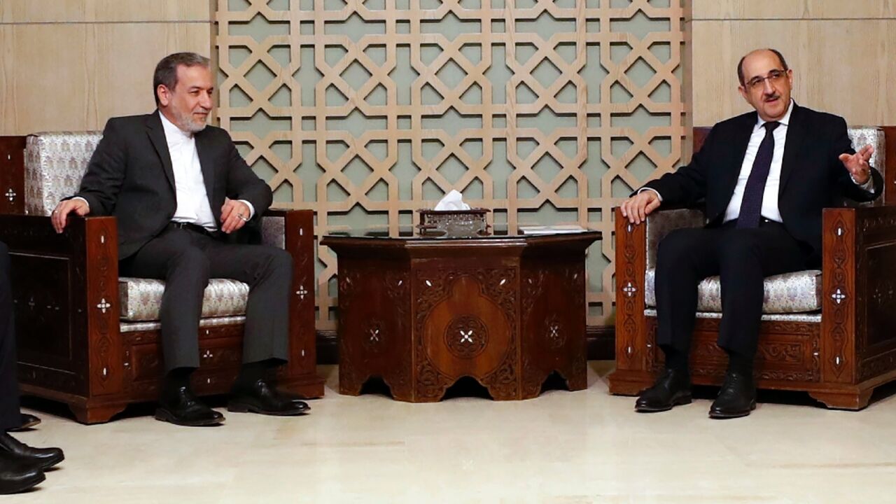 Iranian Foreign Minister Abbas Araghchi (L) holds talks in Damascus with his Syrian counterpart Bassam al-Sabbagh