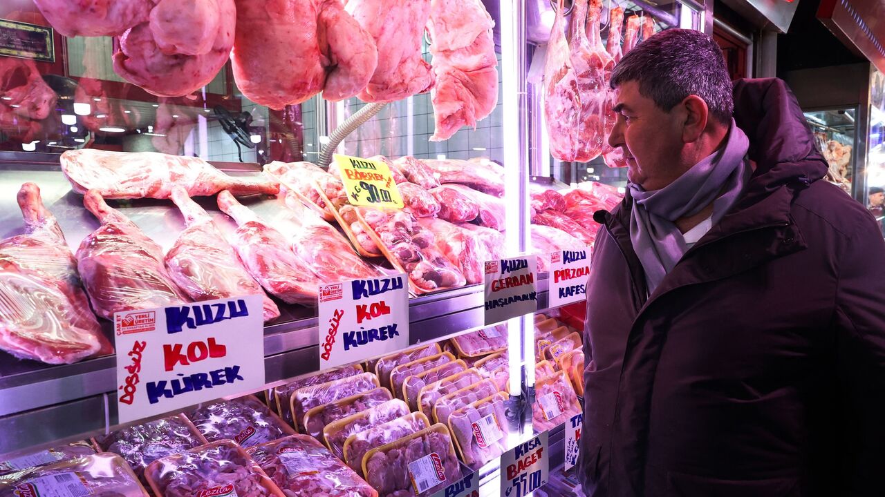 A man looks at high meat prices at a butcher in the historic Ulus district in Ankara on Jan. 27, 2023. 