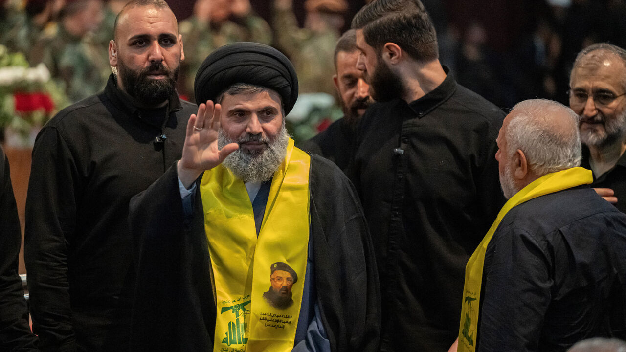 Senior Hezbollah official Hashem Safieddine (C) attends the funeral ceremony of slain top commander Fuad Shukr in Beirut's southern suburbs on August 1, 2024. Hezbollah on August 1 mourned Shukr, whose body was recovered from the rubble of a July 30 Israeli strike in south Beirut that also killed five civilians, three women and two children, and injured dozens, according to Lebanon's health ministry, as fears mounted of a wider conflict in the region. (Photo by Khaled DESOUKI / AFP) (Photo by KHALED DESOUKI