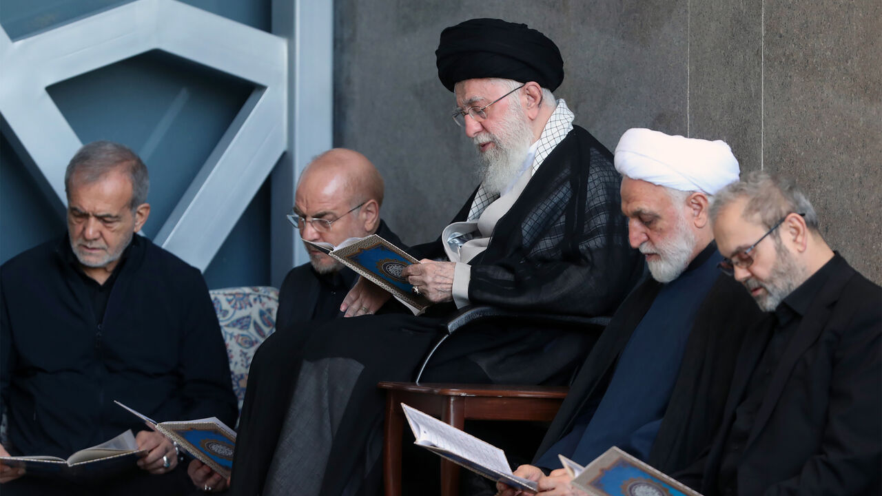 In this handout image provided by the Iranian Leader's Press Office, Iranian Supreme leader Ali Khamenei (C) is seen alongside Iran's President Masoud Pezeshkian (L), Parliament Speaker Mohammad Bagher Ghalibaf (2L), Judiciary Chief Mohsen Ejeie (2R) and Hezbollah representative in Iran Abdallah Safieddine reading the Koran during the Friday prayer ceremony on October 04, 2024 in Tehran, Iran.