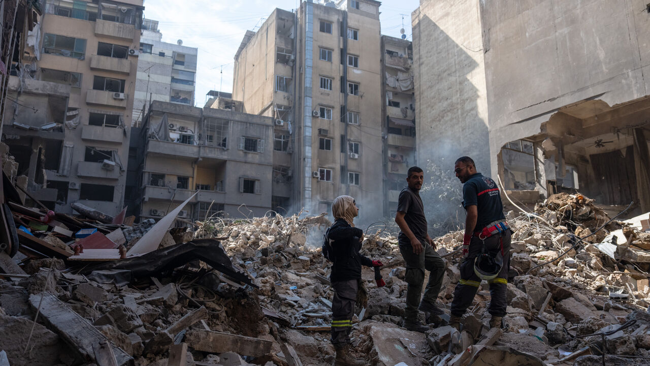 BEIRUT, LEBANON - OCTOBER 11: Emergency workers stand on rubble at the site of an Israeli airstrike on October 11, 2024 in Beirut, Lebanon. At least 22 people died, and over 100 were injured, in the strike in central Beirut last night, according to Lebanese officials. Israel said the target was a high-ranking Hezbollah official. (Photo by Carl Court/Getty Images)