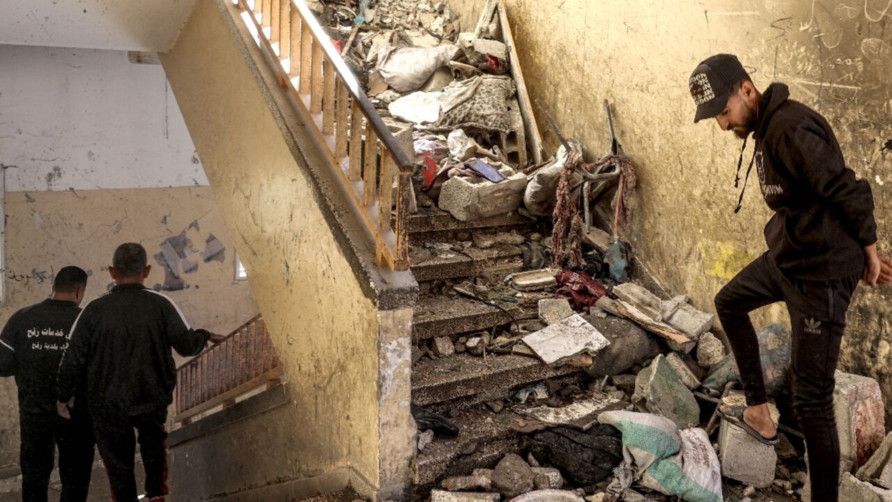 A stairwell littered with rubble and debris in central Gaza's Al-Shuhada school, which was hit by Israeli bombardment