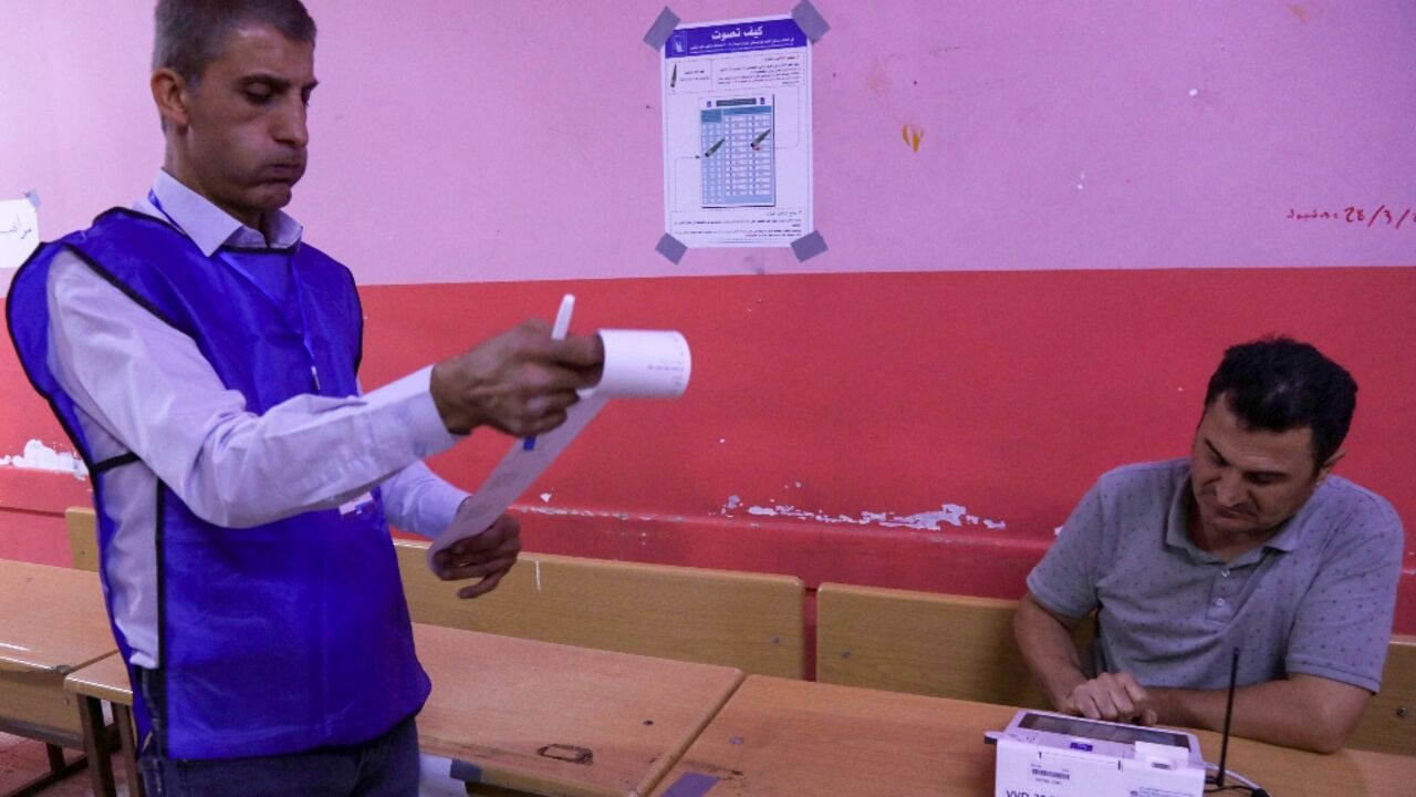 Electoral commission workers count votes at the end of the parliamentary election in Iraq's autonomous Kurdistan region