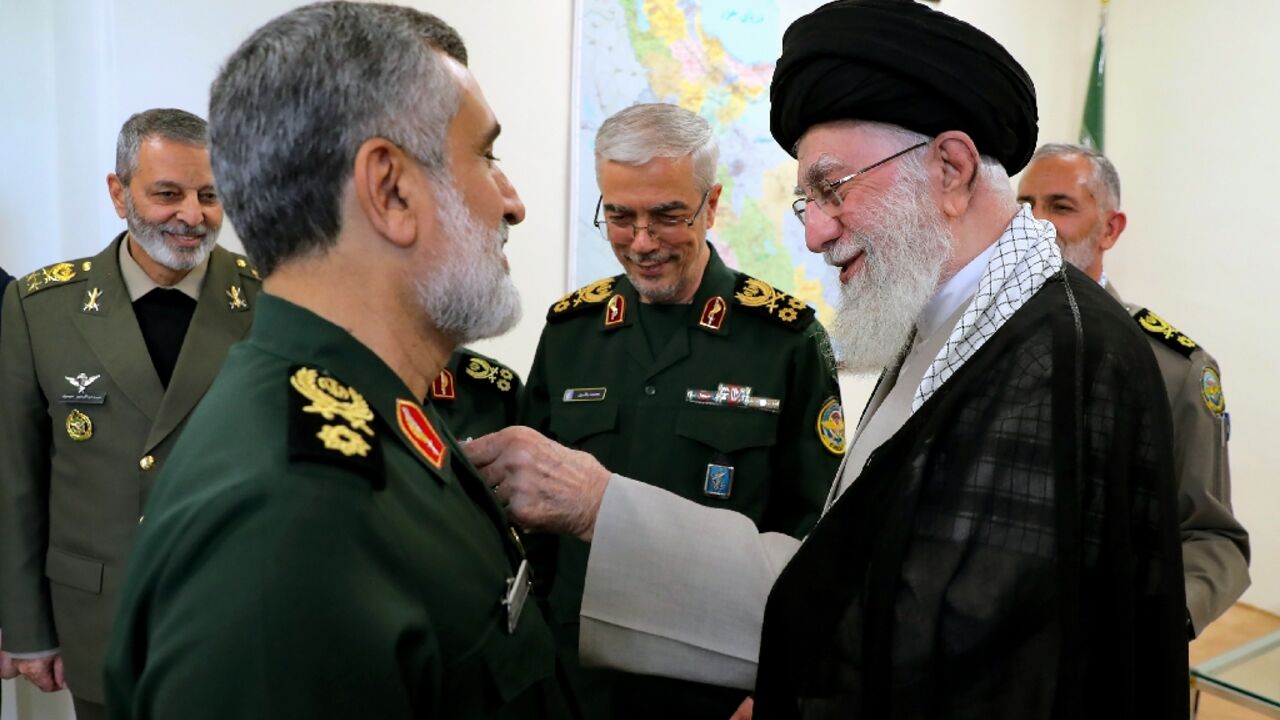 A picture provided by Iranian supreme leader Ayatollah Ali Khamenei's office shows him decorating General Amirali Hajizadeh