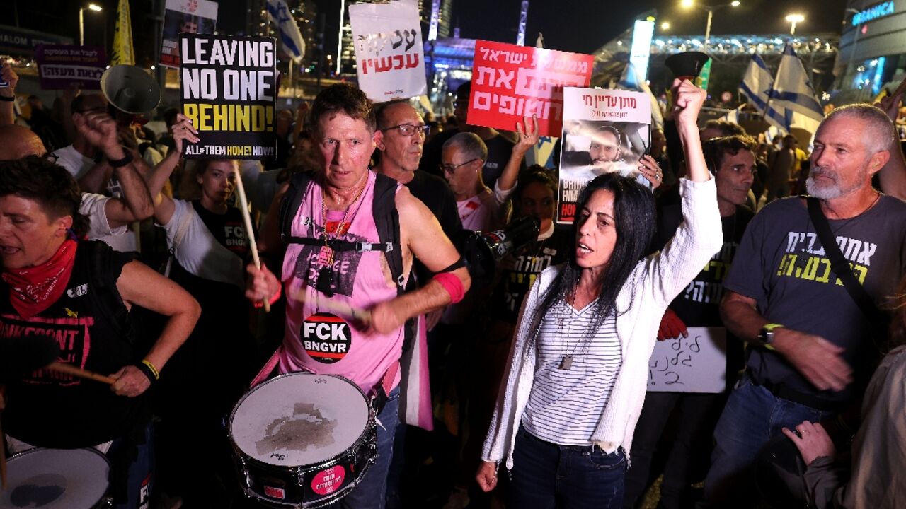 Israelis demanding the return of Gaza hostages block a road in Tel Aviv after Gallant was dismissed