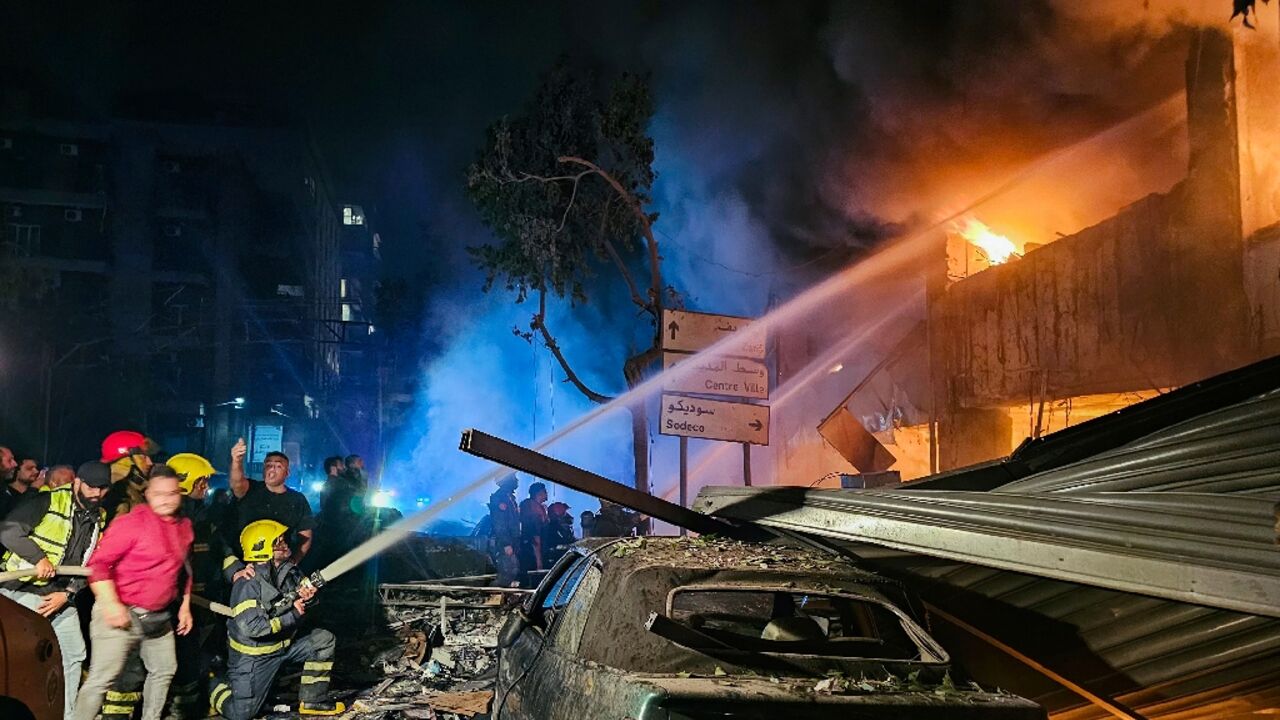 Firefighters douse flames at the site of an Israeli strike on a building in the Lebanese capital