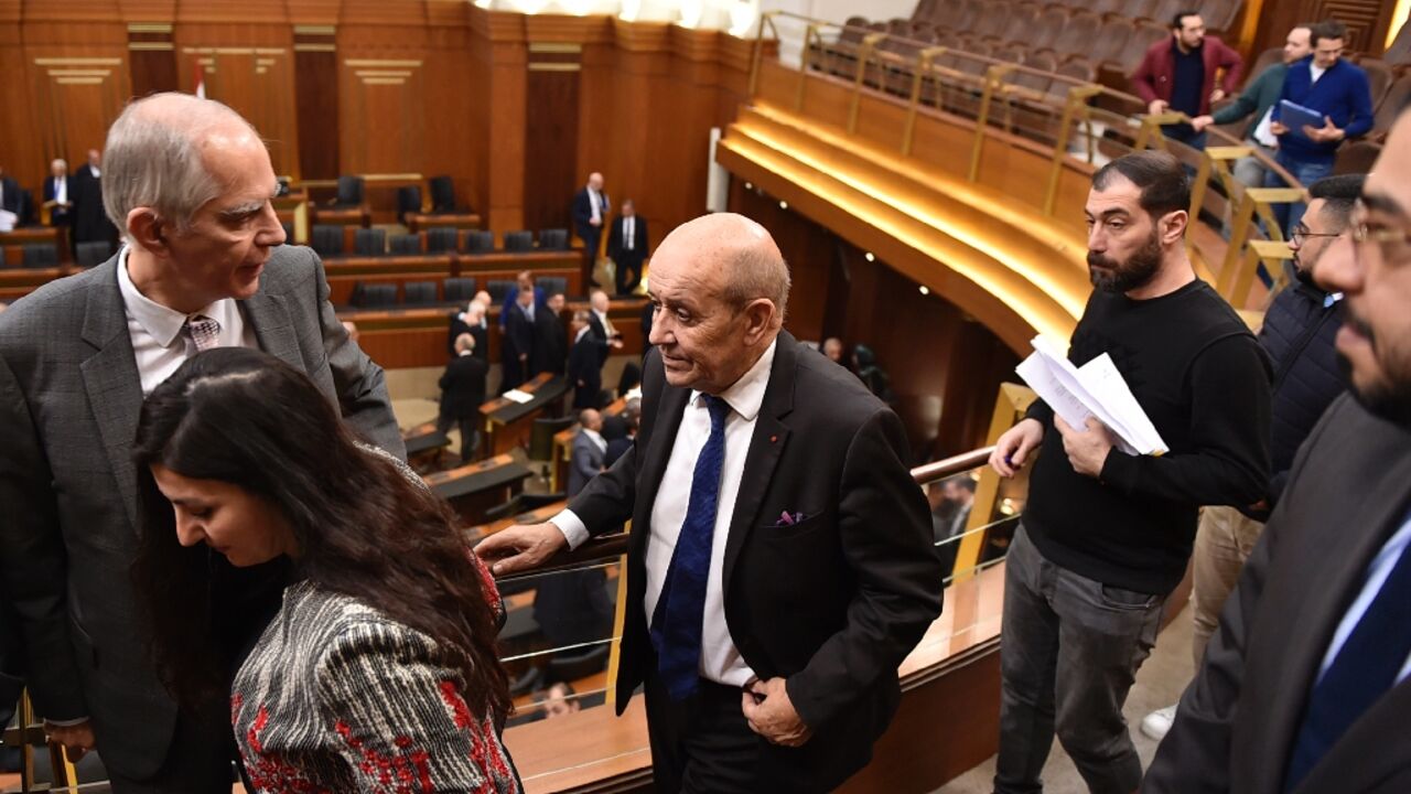 France's envoy to Lebanon Jean-Yves Le Drian (C) and France's ambassador to Lebanon Herve Magro (L), arrive for a parliamentary session at the Lebanese parliament in Beirut