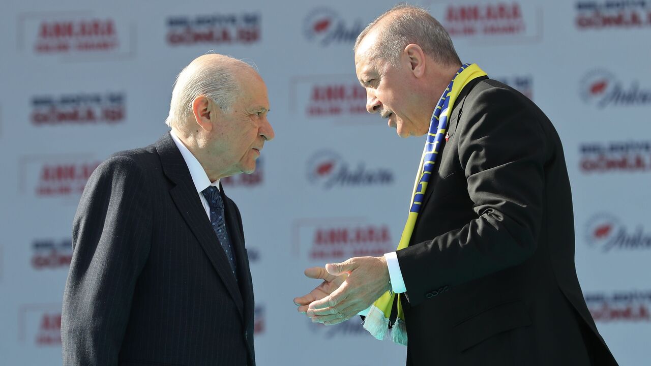 Turkey's President Tayyip Erdogan (R) and the  leader of the Nationalist Movement Party (MHP), Devlet Bahceli, talk on stage during a rally before local elections in Ankara, March 23, 2019.