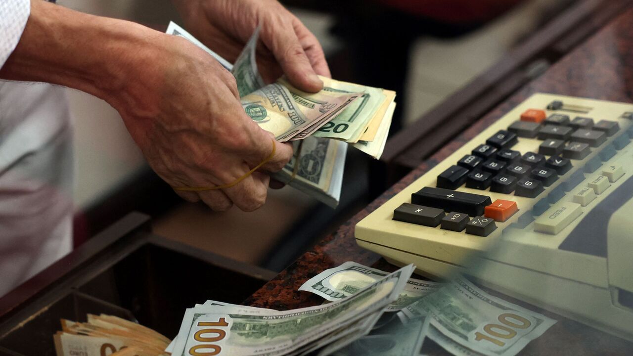 A teller counts US dollar bills at an exchange office, Ankara, Turkey, July 20, 2023.