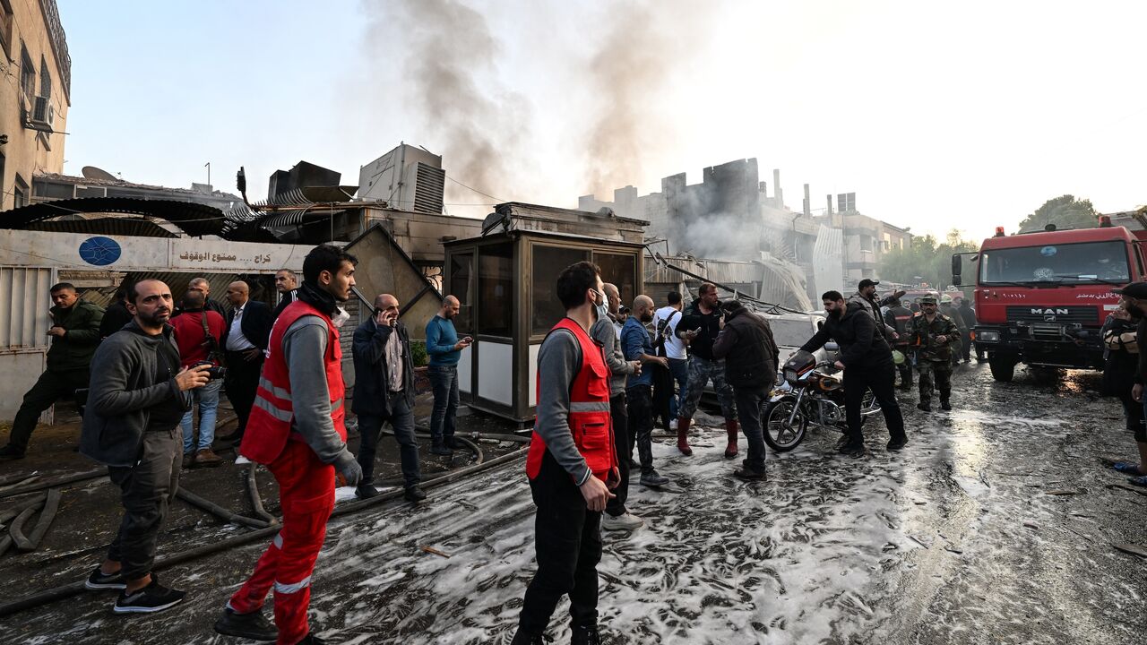 People check the damage following a reported Israeli strike in the Mazzeh district of Damascus, on Nov. 14, 2024.