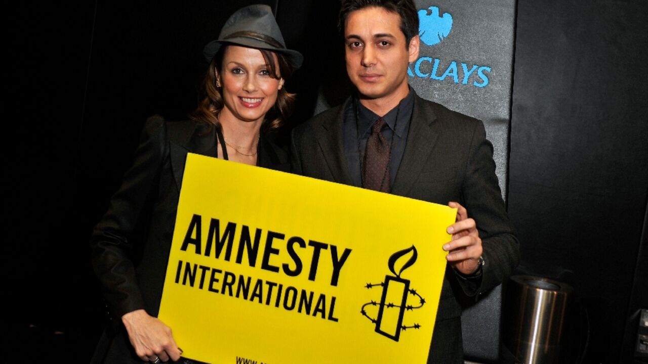 ctress Bridget Moynahan (L) and activist Kianoosh Sanjari at an Amnesty International Concert in New York