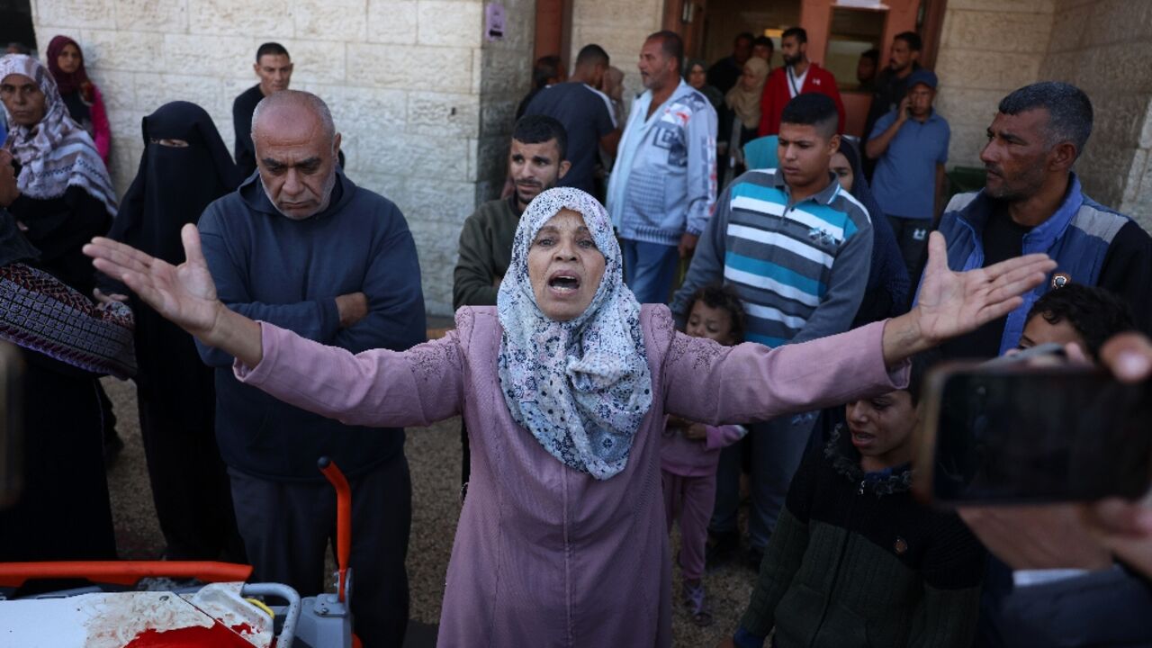 A Palestinian woman reacts as victims of an Israeli strike are transported to the al-Aqsa Martyrs Hospital in Deir el-Balah in the central Gaza Strip on November 17, 2024