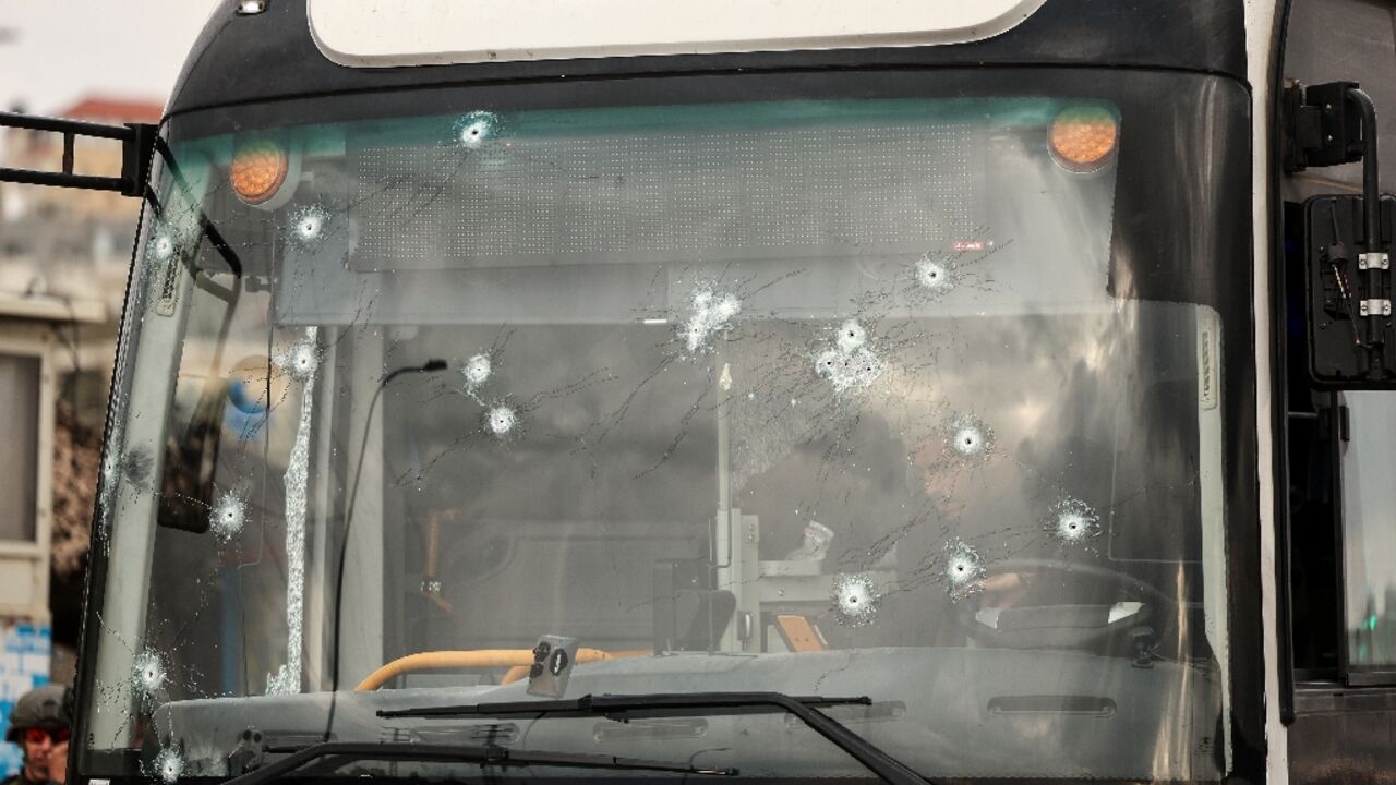 The shooting left more than a dozen bullet holes in the bus windshield 