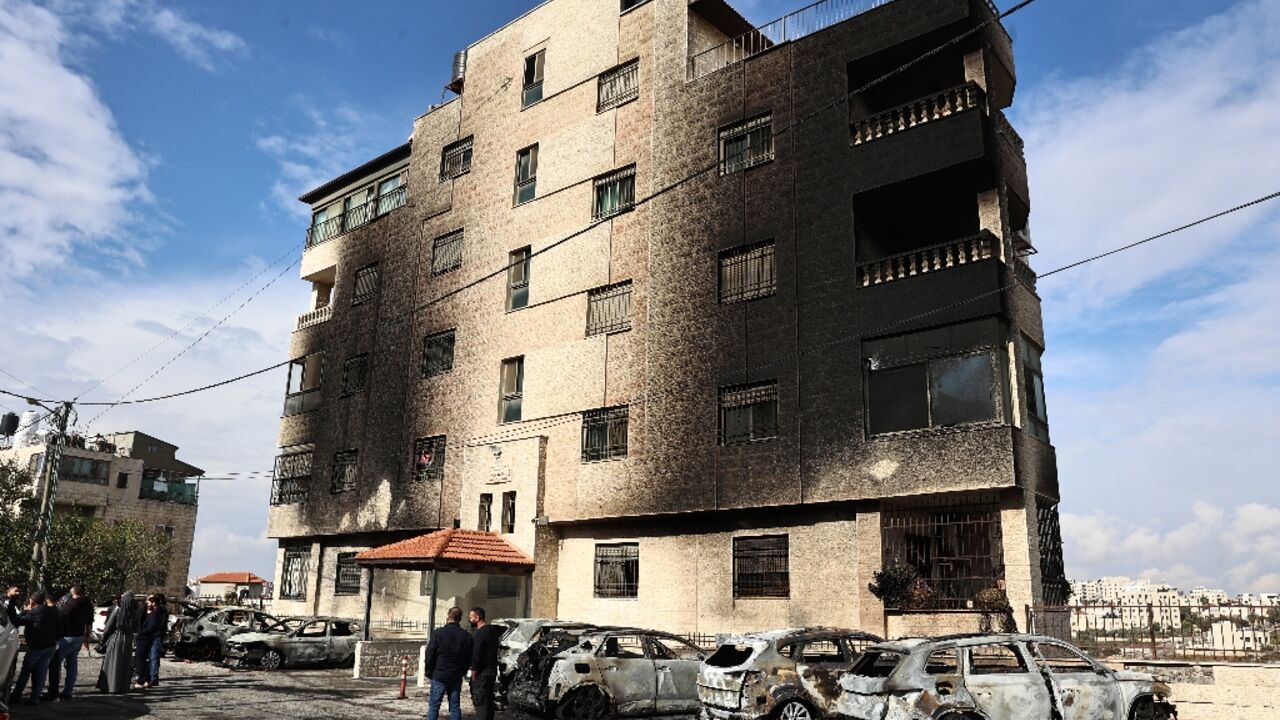 Aftermath of the settler attack: burned out cars and a building's scorched facade