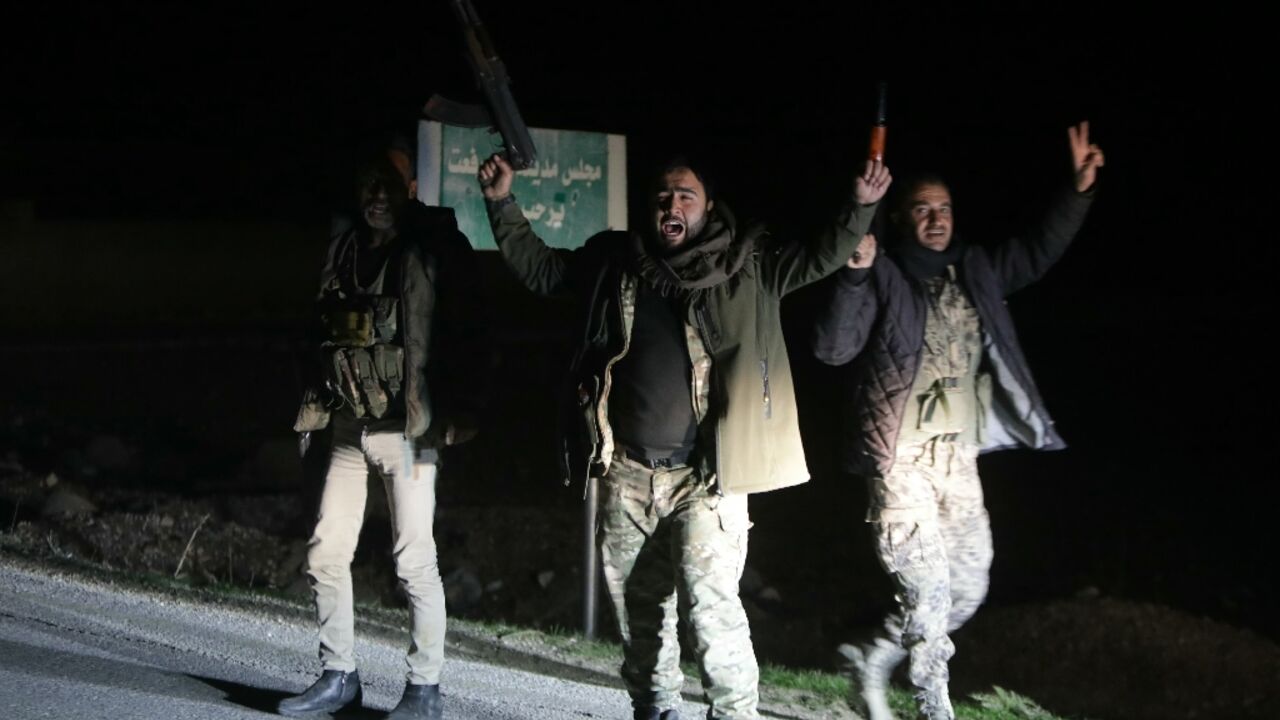 Pro-Turkey fighters celebrate in Syria's northern town of Tal Rifaat