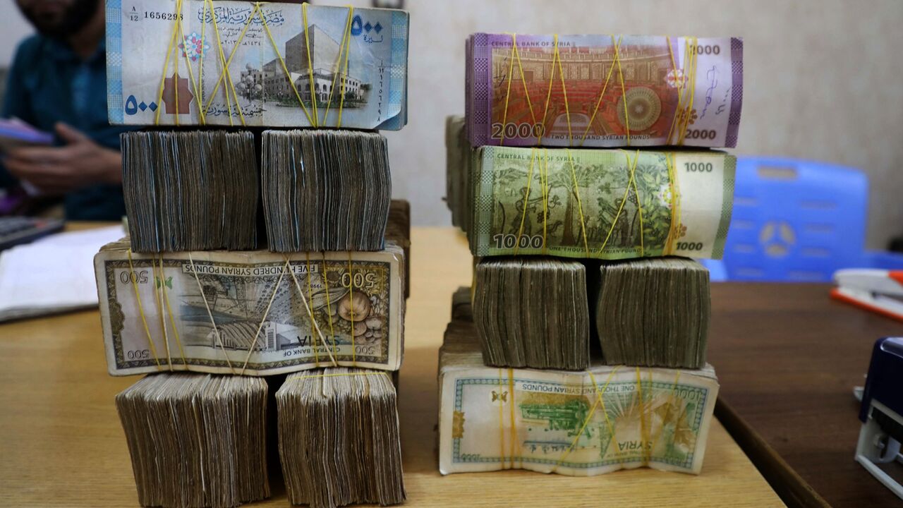 Syrian pounds are pictured at a currency exchange shop in the town of Sarmada in Syria's northwestern Idlib province, on June 15, 2020. 