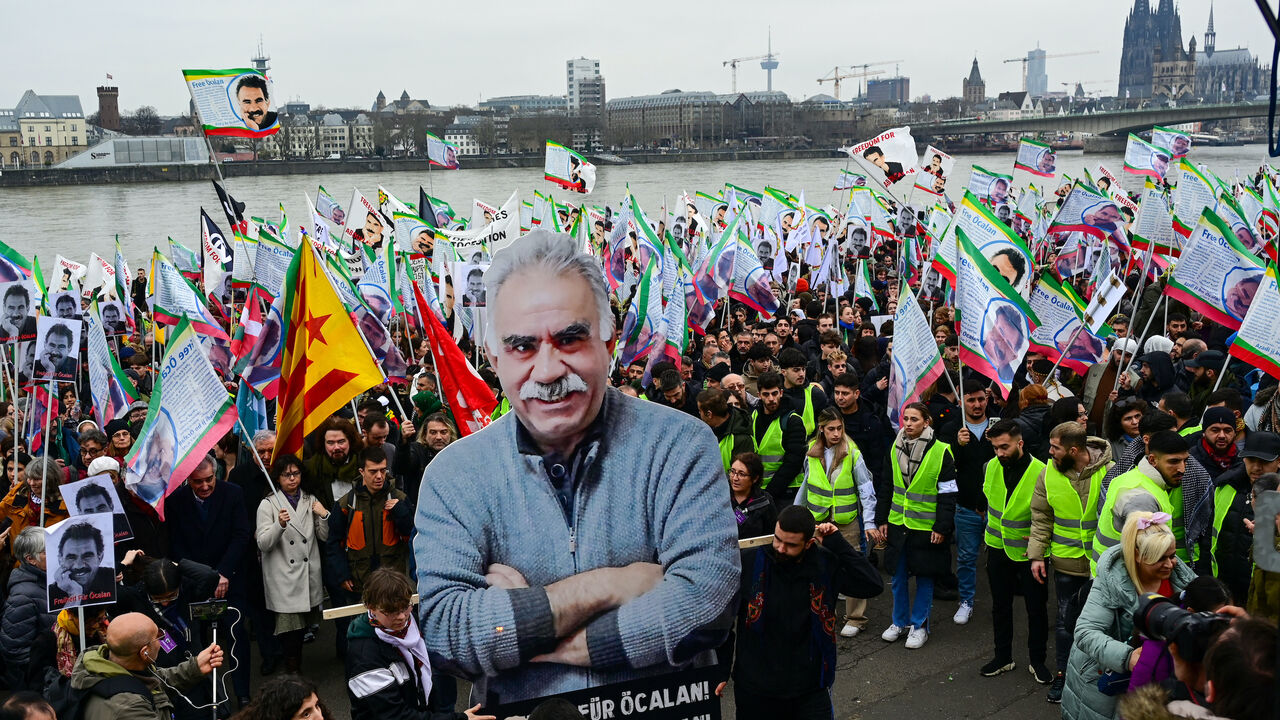 Supporters of the Kurdish community demonstrate with flags and banners on the occasion of the 25th anniversary of the arrest of Kurdistan Workers Party (PKK) leader Abdullah Ocalan on the banks of the Rhine river in Cologne, western Germany, on Feb. 17, 2024. 