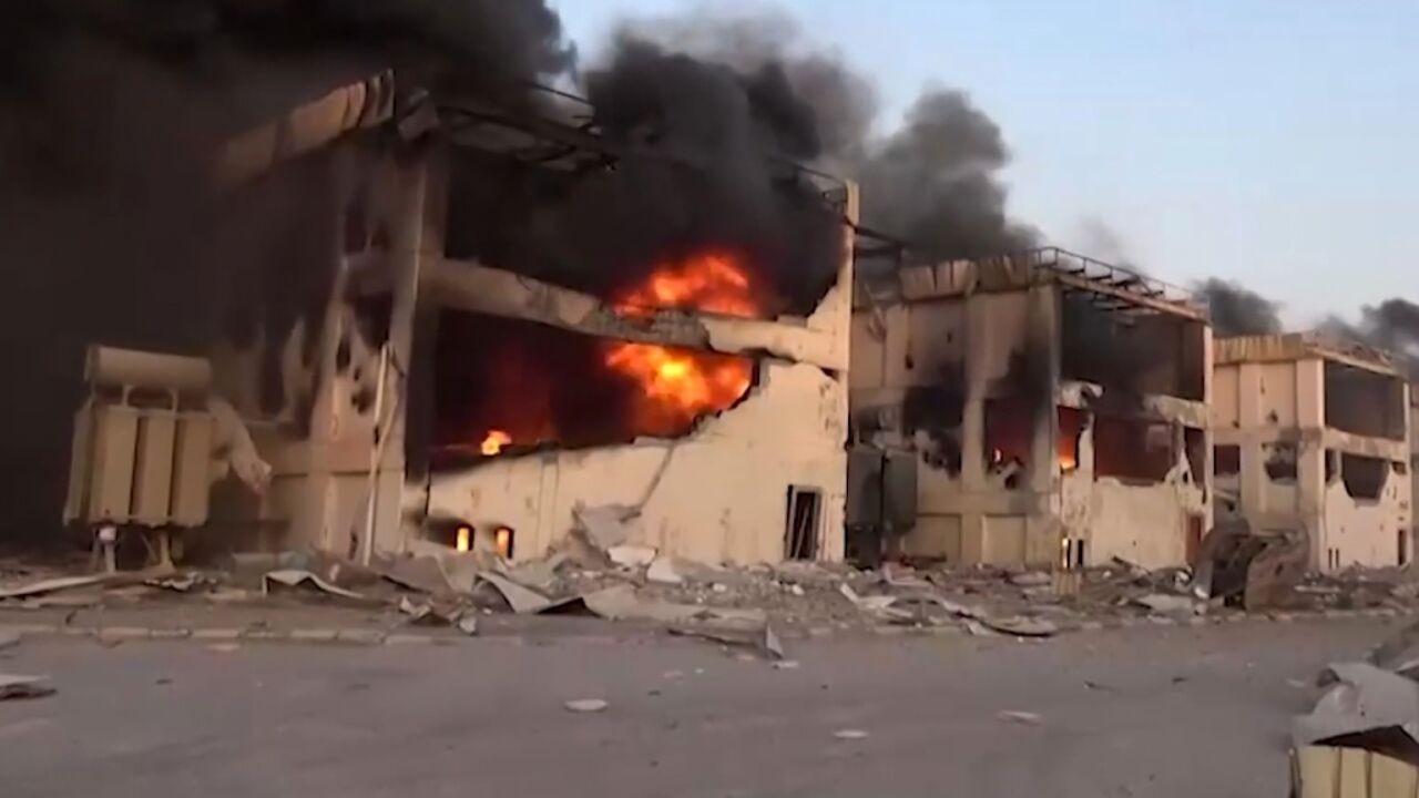 An image grab from a handout video provided by Yemen's Huthi rebels' Al-Masirah TV shows burning buildings following Israeli strikes on the Ras Kutaib power station in Hodeida