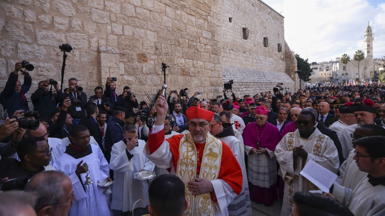 Latin Patriarch of Jerusalem Pierbattista Pizzaballa leads a Christmas procession outside the Church of the Nativity in Bethlehem