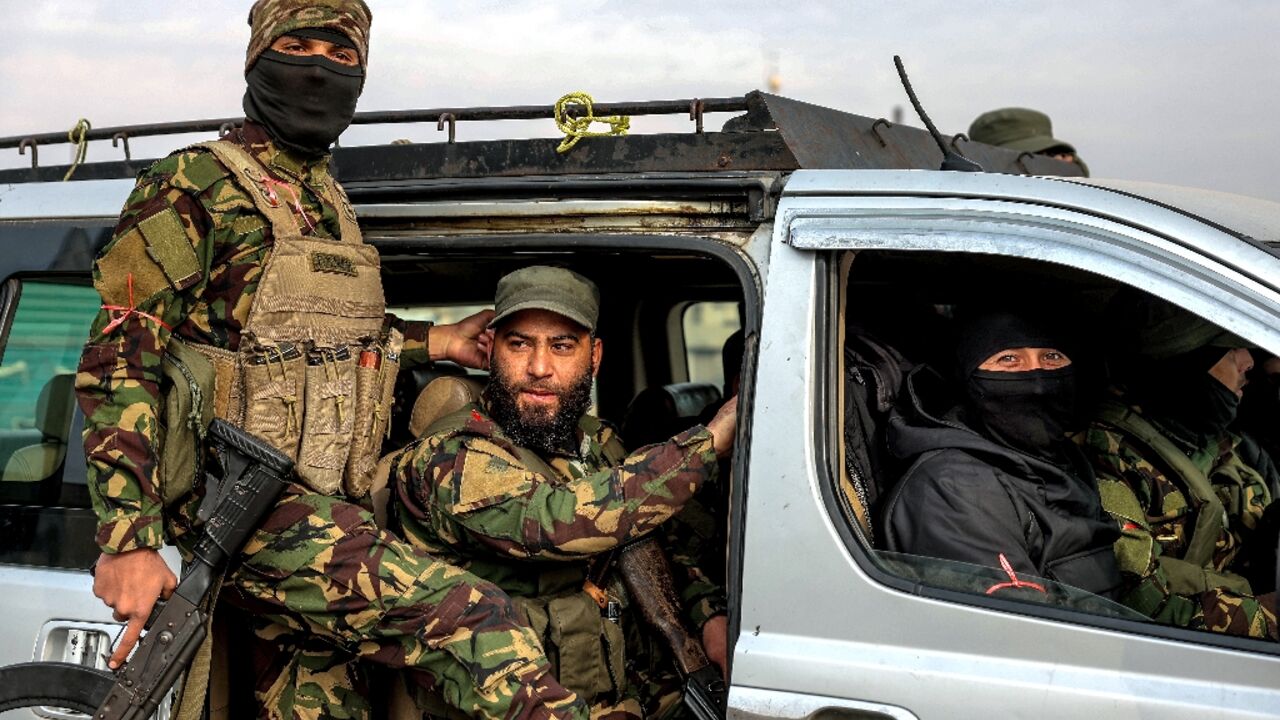 Fighters loyal to the interim Syrian government, in the Zahra district of Homs