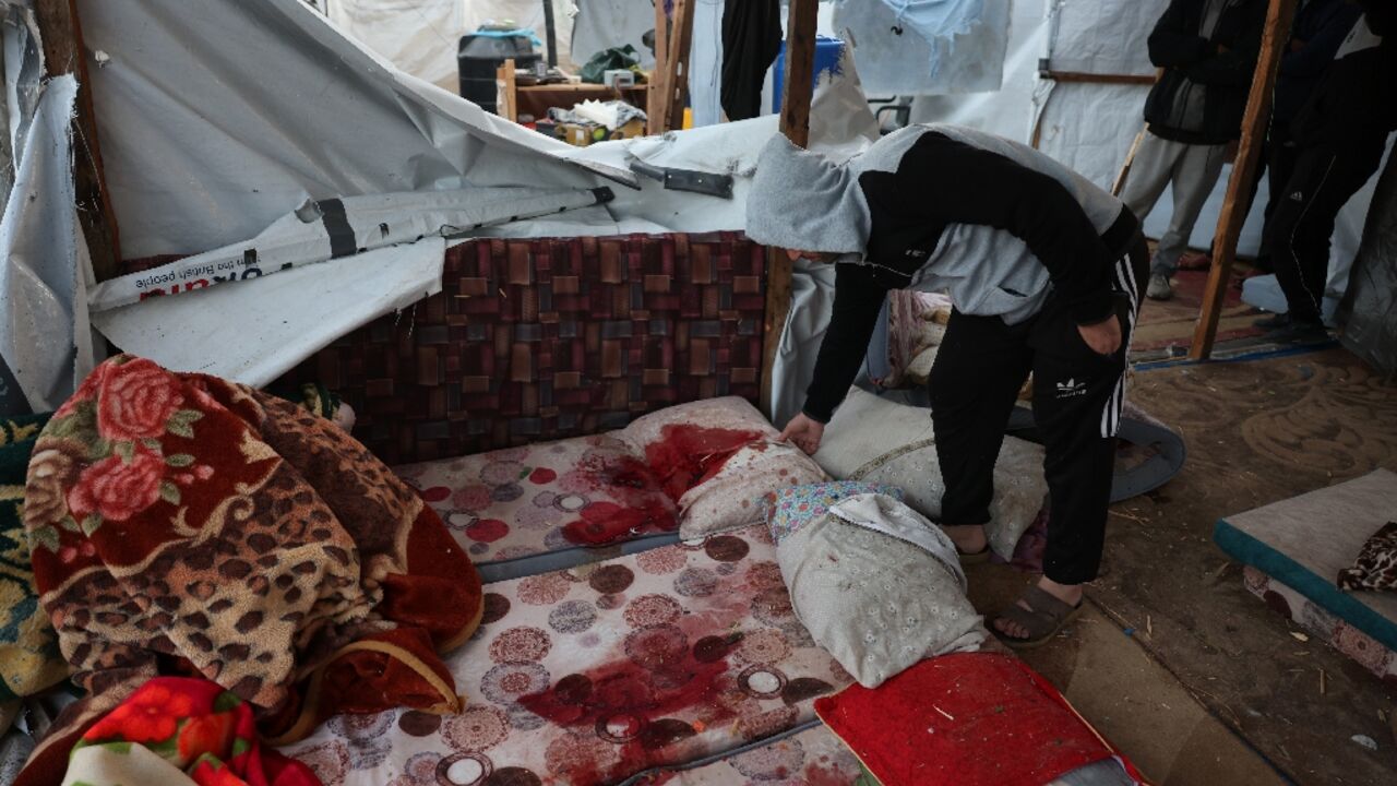 Blood-stained mattresses inside a tent following an overnight Israeli strike in the southern Gaza Strip