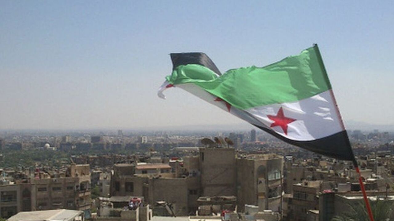 An opposition flag is seen over neighborhood Ruknuddin in Damascus August 5, 2012. Picture taken August 5, 2012. REUTERS/Shaam News Network/Handout (SYRIA - Tags: POLITICS CIVIL UNREST) FOR EDITORIAL USE ONLY. NOT FOR SALE FOR MARKETING OR ADVERTISING CAMPAIGNS. THIS IMAGE HAS BEEN SUPPLIED BY A THIRD PARTY. IT IS DISTRIBUTED, EXACTLY AS RECEIVED BY REUTERS, AS A SERVICE TO CLIENTS