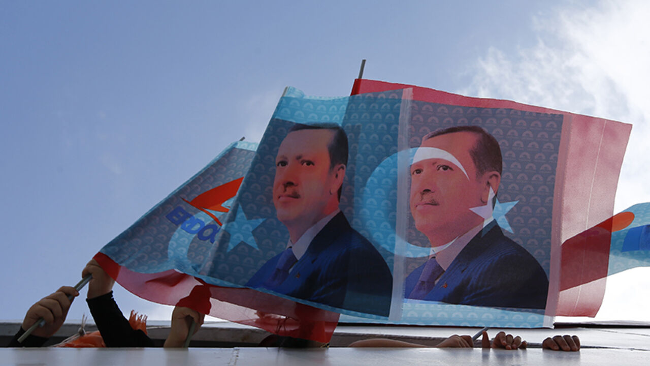 Supporters of Turkey's Prime Minister and presidential candidate Tayyip Erdogan wave flags in a boat on their way to an election rally in Istanbul August 3, 2014. Cheers erupted from the packed stands when Erdogan scored his third goal in a celebrity soccer match to mark the opening of an Istanbul stadium. His orange jersey bore the number 12, a reminder of Erdogan's ambition to become the nation's 12th president in Turkey's first popular vote for its head of state, on Aug. 10. After dominating Turkish poli