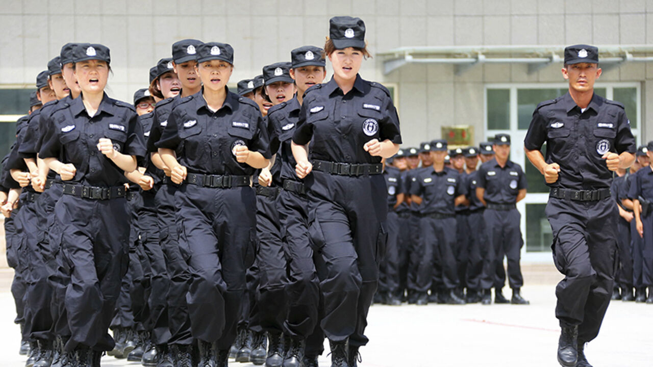 Policewomen from Special Weapons and Tactics (SWAT) team run in formation during a graduation performance after training as members of an anti-terrorist patrol team, in Hami, Xinjiang Uighur Autonomous Region June 29, 2014. Picture taken June 29, 2014. REUTERS/China Daily (CHINA - Tags: MILITARY CRIME LAW) CHINA OUT. NO COMMERCIAL OR EDITORIAL SALES IN CHINA - RTR3WKJW