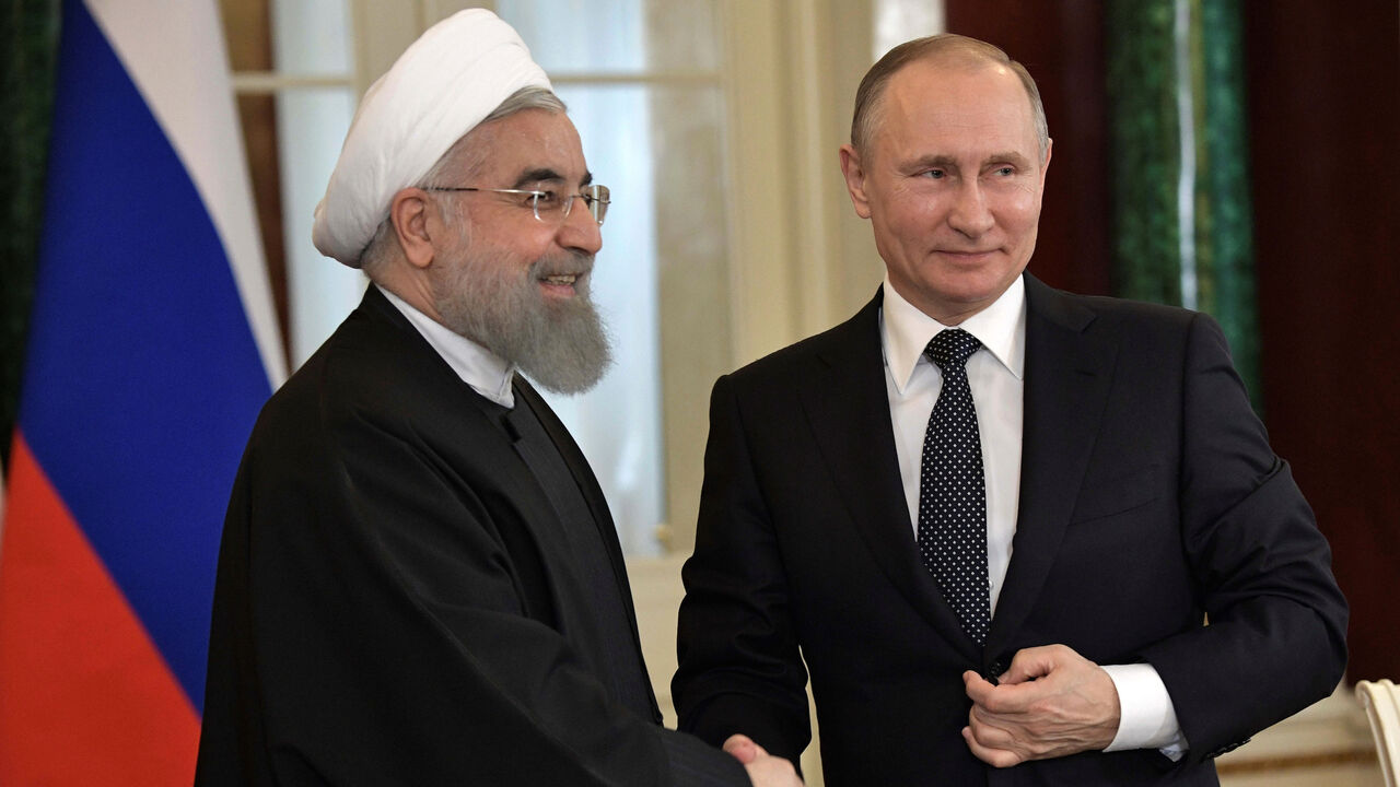 Russian President Vladimir Putin shakes hands with Iranian President Hassan Rouhani during a joint news conference following their meeting at the Kremlin in Moscow, Russia March 28, 2017.  Sputnik/Aleksey Nikolskyi/Kremlin via REUTERS ATTENTION EDITORS - THIS IMAGE WAS PROVIDED BY A THIRD PARTY. EDITORIAL USE ONLY. - RC1DD5047B80