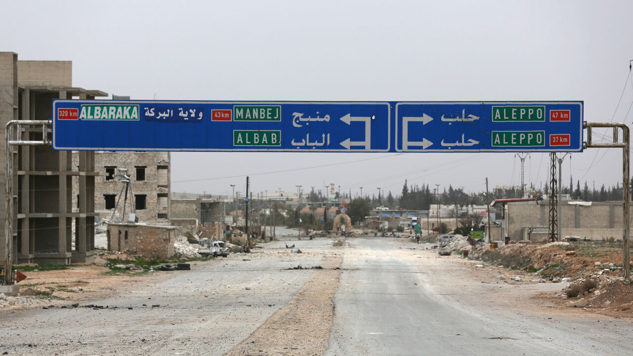 A road sign that shows the direction to Manbij city is seen in the northern Syrian town of al-Bab, Syria March 1, 2017. Picture taken March 1, 2017. REUTERS/Khalil Ashawi - RC15D78AB000