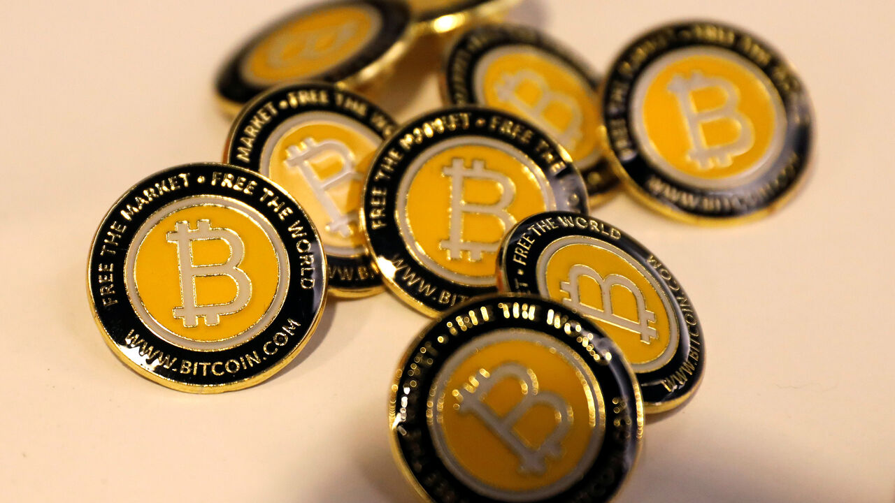 Bitcoin.com buttons are seen displayed on the floor of the Consensus 2018 blockchain technology conference in New York City, New York, U.S., May 16, 2018. REUTERS/Mike Segar - RC1B17B79620