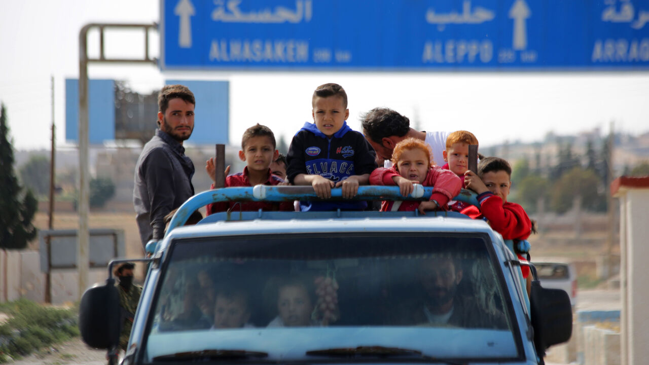 Syrians return to their homes in the town of Ayn al-Arus, south of the border town of Tal Abyad, on October 14, 2019, after it was taken over by Turkish-backed Syrian fighters during their assault on Kurdish-held border towns in northeastern Syria. - Syrian regime forces moved towards the Turkish border after Damascus reached a deal with beleaguered Kurdish forces following a US withdrawal announcement, AFP correspondents reported. (Photo by Bakr ALKASEM / AFP) (Photo by BAKR ALKASEM/AFP via Getty Images)